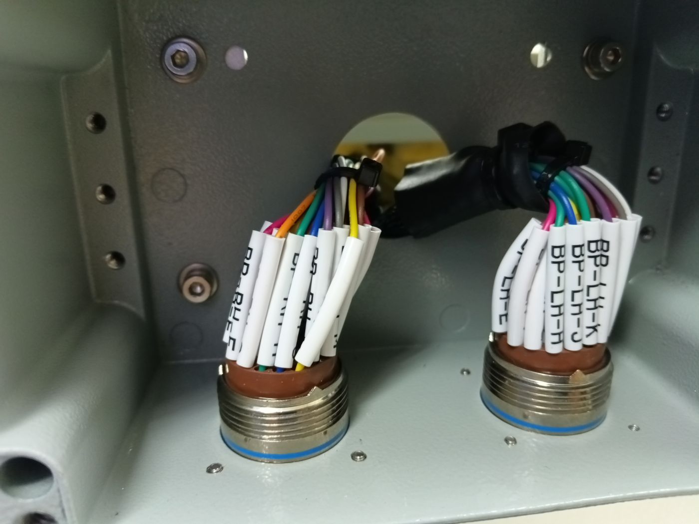 Wiring harness terminated into two circular aircraft-style connectors, every wire sleeved and labelled